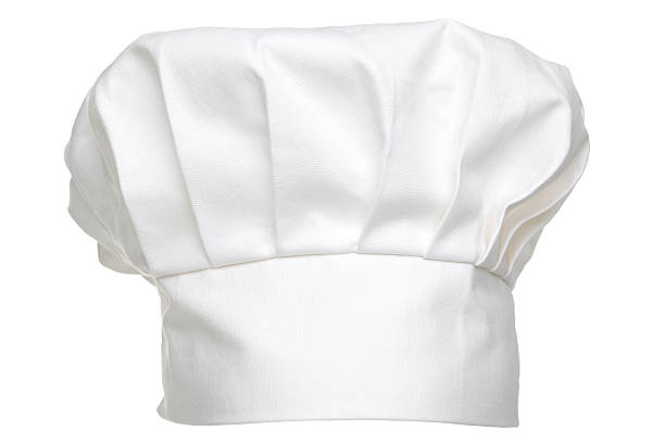 A classic white chef hat, featuring pleated fabric and a wide band, typically worn by chefs in professional kitchens to signify expertise and maintain hygiene.