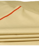 Folded fabric in a beige colour with a red stripe along the edge, showcasing its smooth texture.