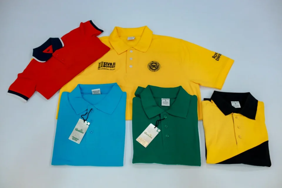 Custom corporate polo t-shirts in red, yellow, blue, green, and dual-tone colors by Reethatex Trivandrum